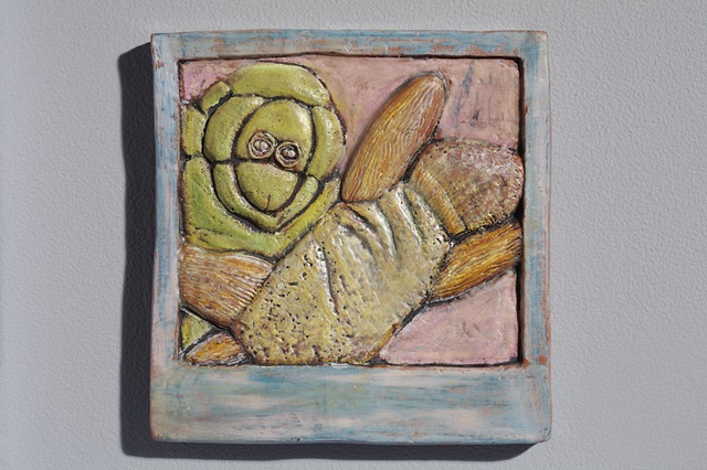 hand cut tile, carved, with encaustic 
