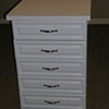 10 drawer white melamine island cabinet with raised panel drawer fronts and laminate countertop