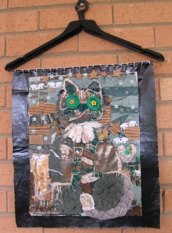 This collage is made with recycled materials. This piece was a part of "Mother Earth Exhibit" at the Public Library in Gastonia, NC