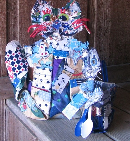 These two blue cat baskets are made with recycled materials.  Crazy quilt pieces are stitched together and connected to a plastic container