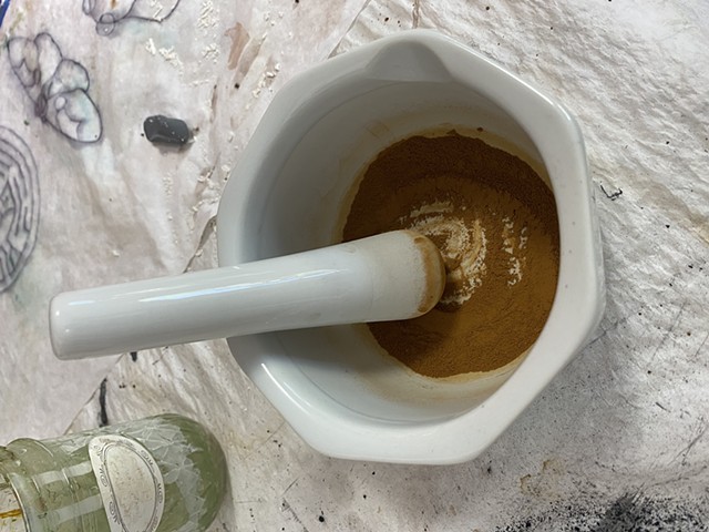grinding process with mortar and pestle (while wearing a mask)