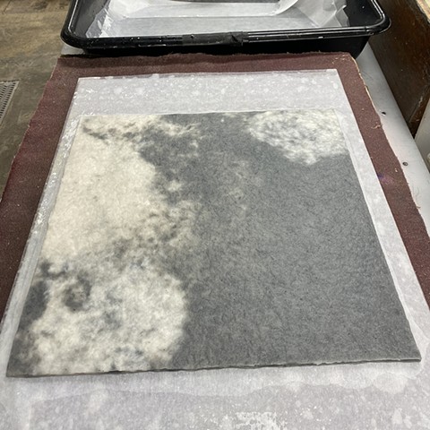 Making paper with abaca dyed with charcoal powder