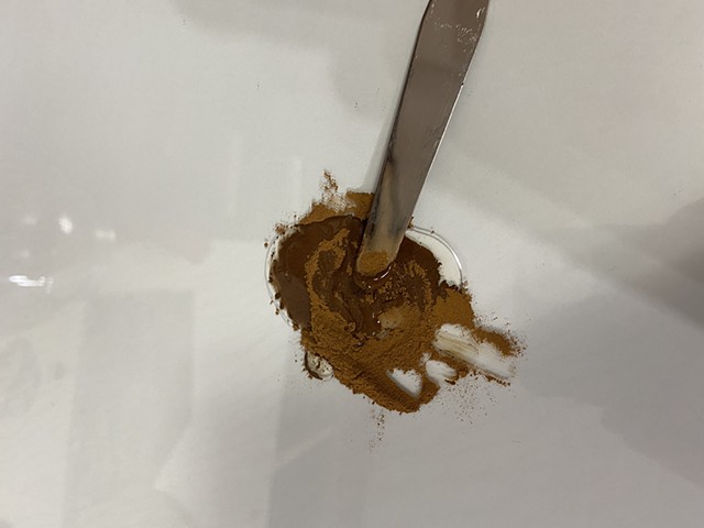 mixing the ground pigment with gum arabic (1/2 t pigment + 1/4 t gum arabic)