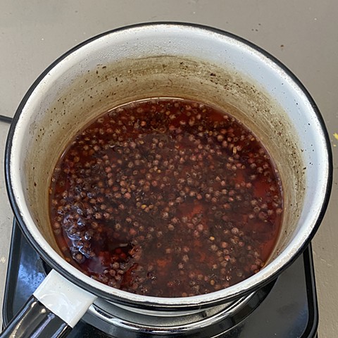 Staghorn sumac drupes (fruit) are simmered for about 1 hour over low heat, allowing the color to concentrate