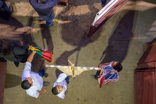 Flag bearers await their cue to enter the bullfighting arena