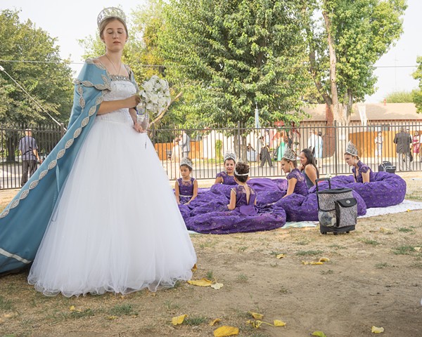 Ladies and their courts try to stay cool in the unrelenting Fall heat of Gustine's Festa de Nossa Sinhora dos Milagres