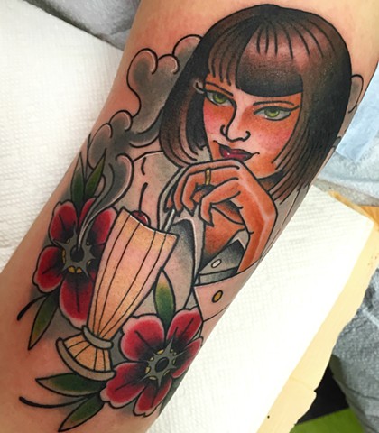 Portrait tattoo of Mia Wallace from Pulp Fiction, done in Traditional style with bold colour. Made in Toronto