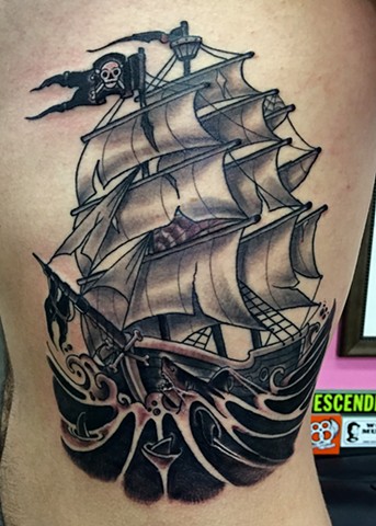 Tall pirate ship in shark infested dark waters, made on the ribs in black and grey tattoo style