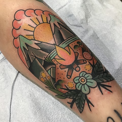 Campfire mountains scene with tent and flower as a bright colour traditional tattoo made in Vancouver BC Canada