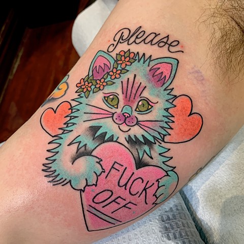 Neon bright colour cute but badass feminine cat tattoo in a traditional style with hearts and flowers made in Toronto Ontario Canada