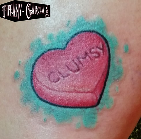 Clumsy Candy Heart by Tiffany Garcia Top Female Tattoo Artist located in Long Beach, Orange County, LA, Huntington Beach, Carson, Palos Verdes, Los Angeles, West Hollywood, Pacific Coast Highway and surrounding areas in Southern California.