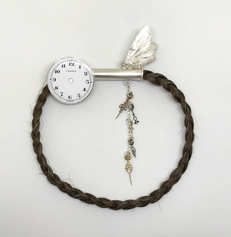 Smulovitz, Longing 16, sterling silver, hair, antique enameled watch face, antique watch hands brooch