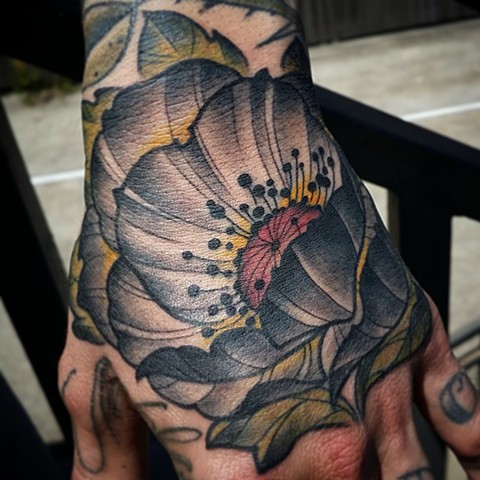 Poppy flower hand tattoo 