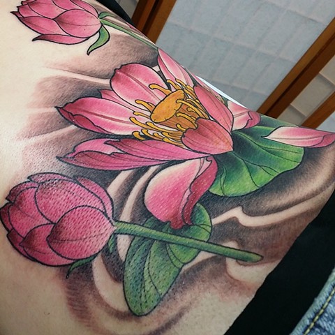 Lotus lower back tattoo by Chris walk in lake Charles Louisiana 
