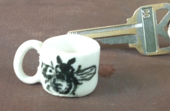 Very small coffee cup with bee painting