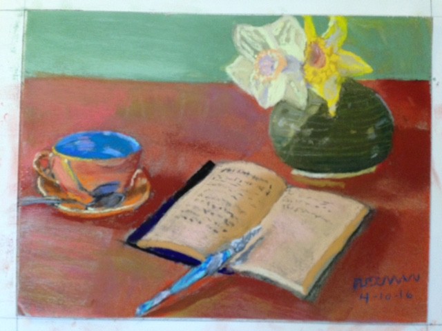 Still life with tea cup & saucer, glass pen, book and vase with two daffodils