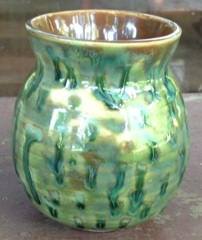 Small green vase with dark green and yellow spots