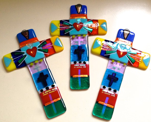 Caribbean Cross for smaller spaces...   

details:
8" tall x 5" wide
glass
hangs by wire on top
$98.00