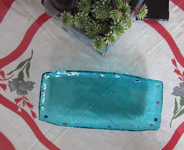 Little serving tray...
Details:
4.5" wide by 9" long
fused glass with dichroic glass jewels around the edge
about 3/4" deep.