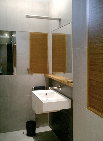 modern minimalist  bathroom, custom aluminum light fixture, walnut medicine cabinet, by Doug Stiles Interior Design