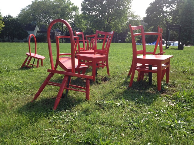 No Place to Sit (NP2S) consists of thirteen vintage wooden chairs of varying styles that have been remixed and reconfigured into a bright red monochrome interlocking body.