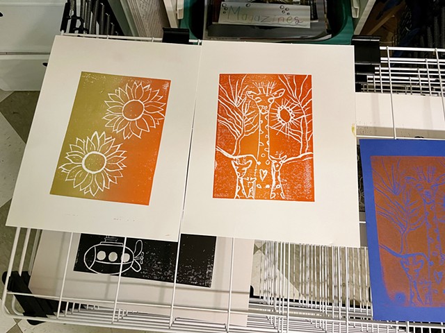 Linoleum prints by M. and J. on drying rack