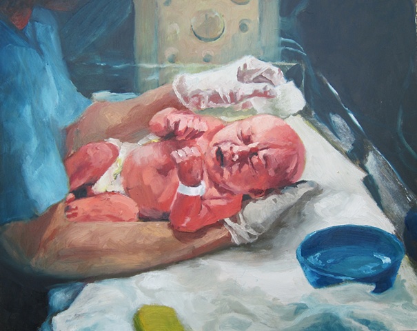 Newborn baby being bathed by nurse in hospital