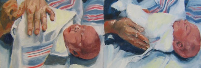 Nurse swaddling a newborn baby in hospital blankets