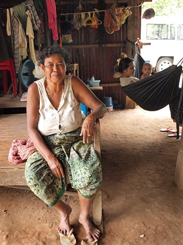 Woman in her home at mango tree village