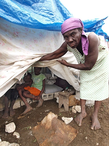 Woman showing her tent camp home
Léogâne