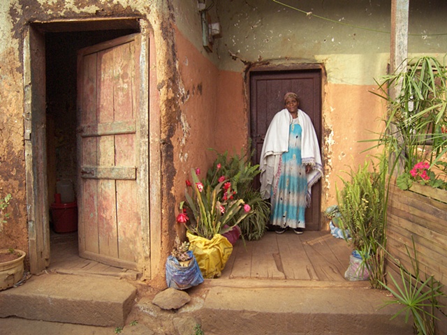Woman in front of her home