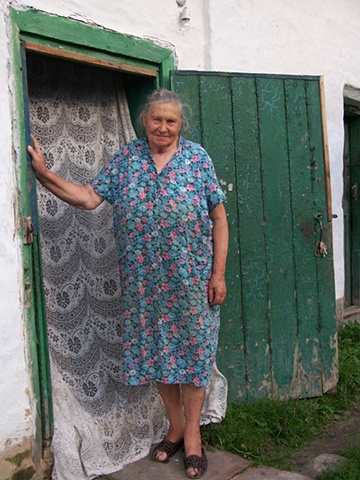 Olya in the doorway of her home