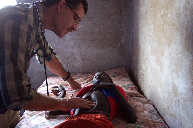 Missionary doctor examining young boy