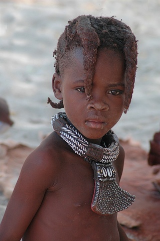 Young Himba girl in a Himba Village at Epupa Falls on the Kunene River Namibia
