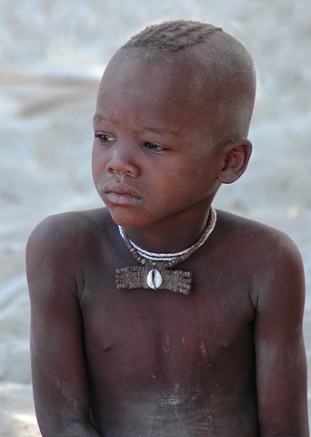 Young Himba boy in a Himba Village at Epupa Falls on the Kunene River Namibia