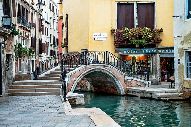 Bridge over the Canal, emerald and turquoise colored waters of Venice, tranquil reflections
