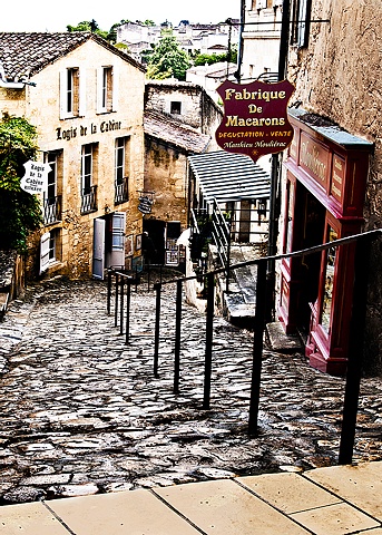 Macarons store in St Emilion France, a steep hill of cobblestone with a store half way down