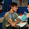 Stina getting tattooed