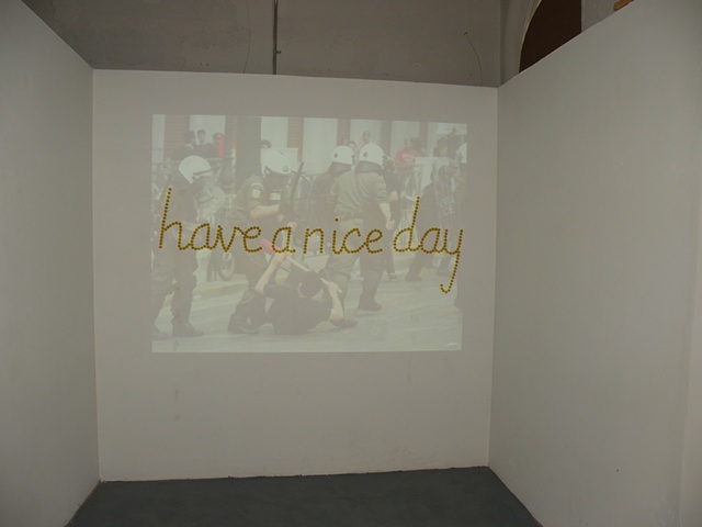 Installation of riot photos.  Have a Nice Day by Courtney Kessel