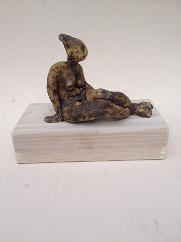 A dark sitting figurine