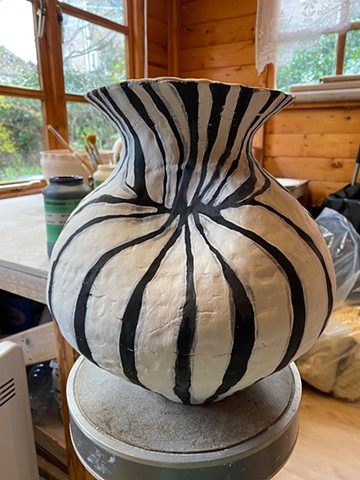 Vase painted with black and white stripes