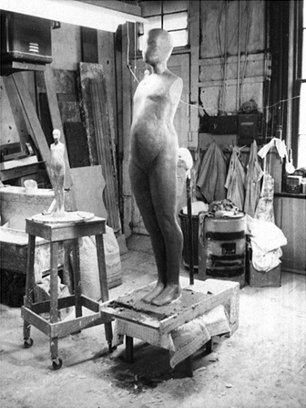 Polaroid of original clay sculpt of six foot FM figure with 24 inch reference casting, circa 1966.