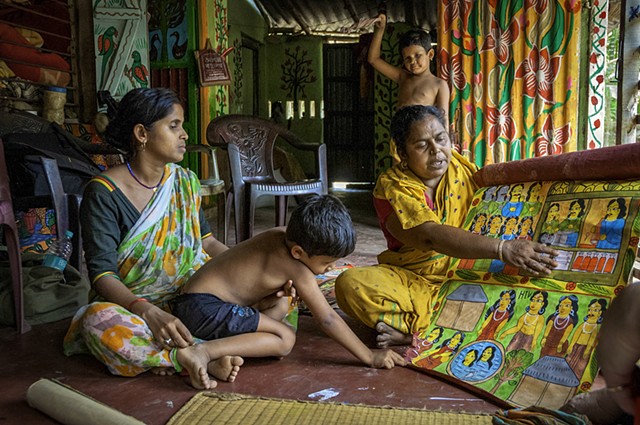 Susama and Rani Chitrakar showing their scroll painting (patua) illustrating the HIV crisis, Naya village, West Bengal, India