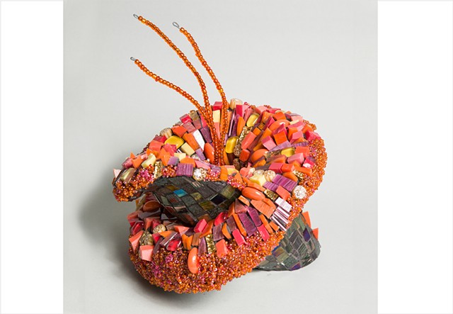 Orange glass encrusted flower mosaic sculpture by Julee Latimer