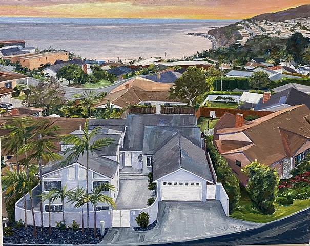 Pacific palisades hillside neighborhood overlooking the Pacific Ocean and out towards Malibu has Hawaiian sunset colors and colorful houses that look warm and inviting.