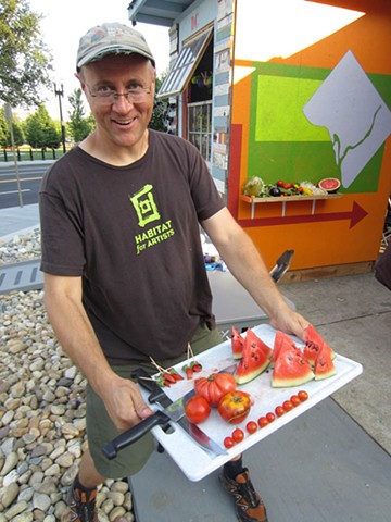Michael Asbill at the Corcoran with vegetables from urban farms.