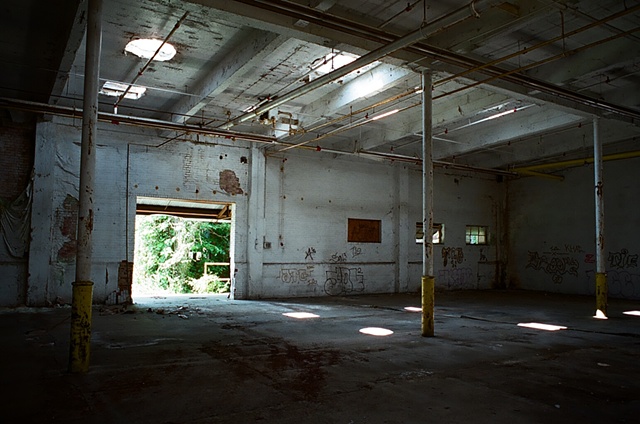 cone mill open door to exterior with light coming in from left to right from top.