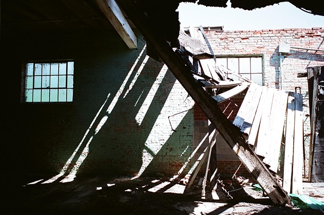 cone mill light falling right to left agains blue wall with hole in roof number two.