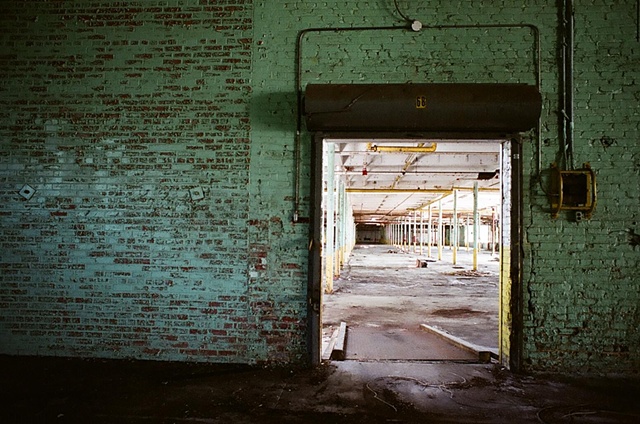 cone mill green wall with door and ramp on right.