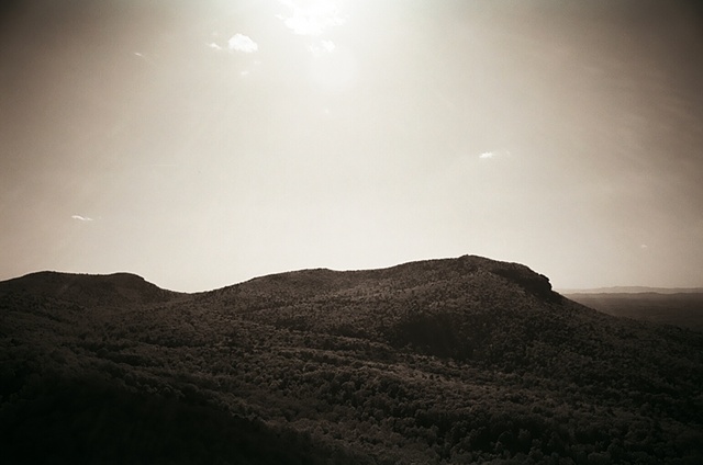 hanging rock black and white with sun out of frame upper middle horizontal.